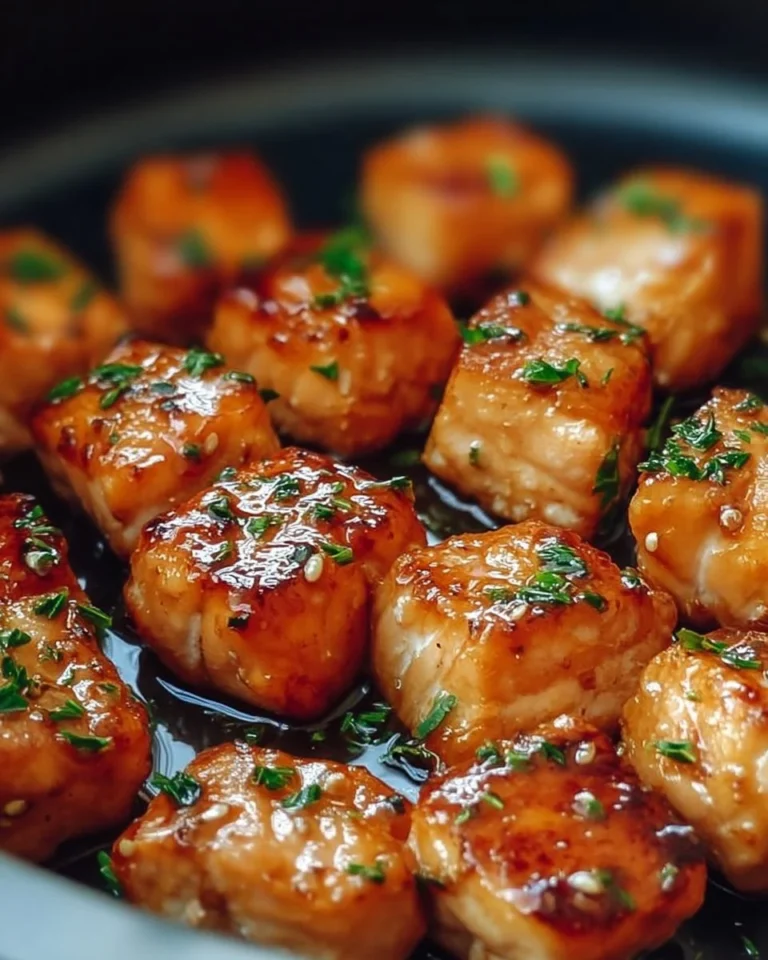 Air Fryer Honey Garlic Salmon Bites served on a plate with fresh herbs