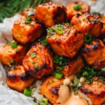 Crispy air fryer salmon bites served with a dipping sauce