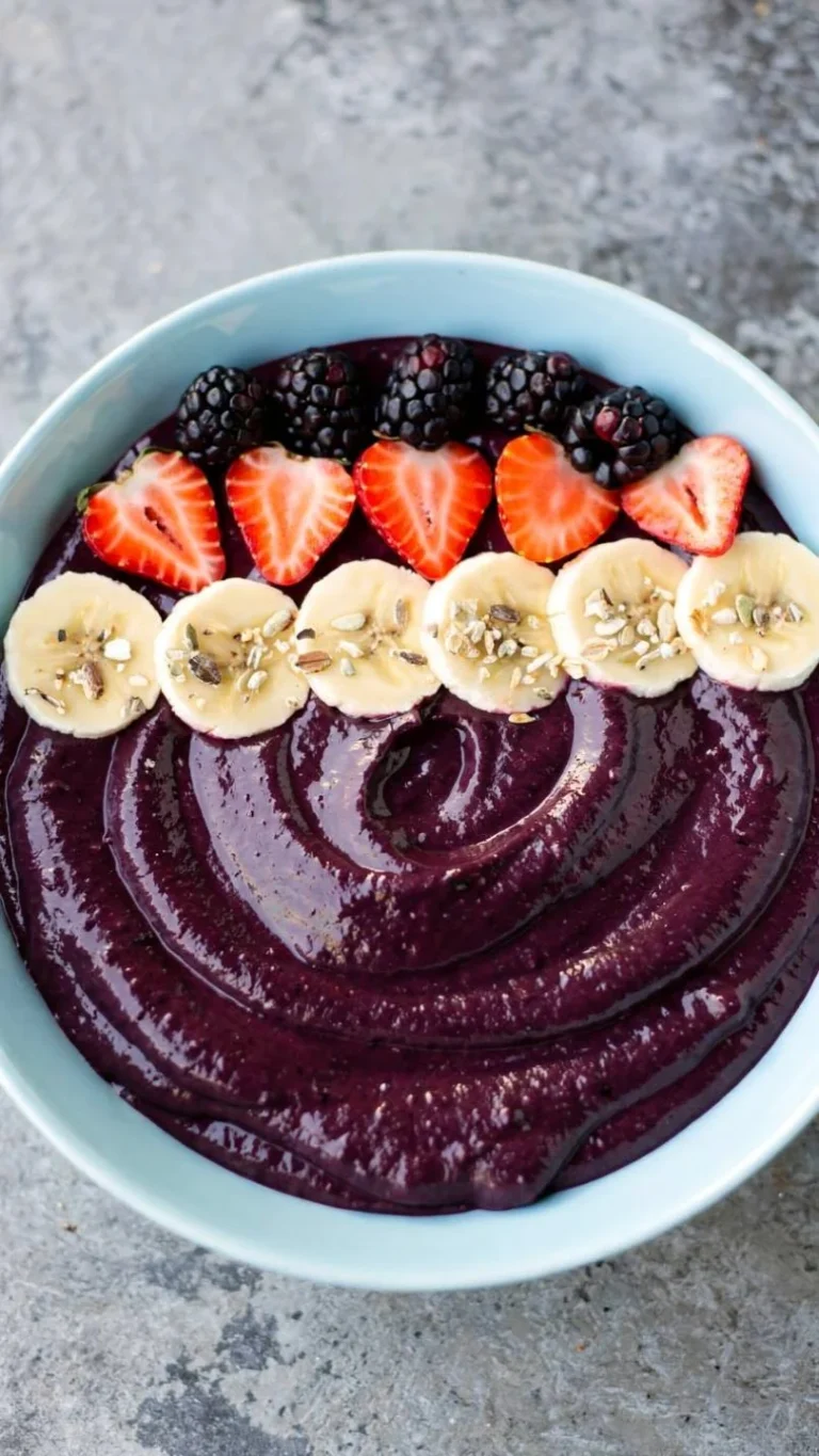 Delicious blackberry smoothie bowl topped with fresh berries and granola