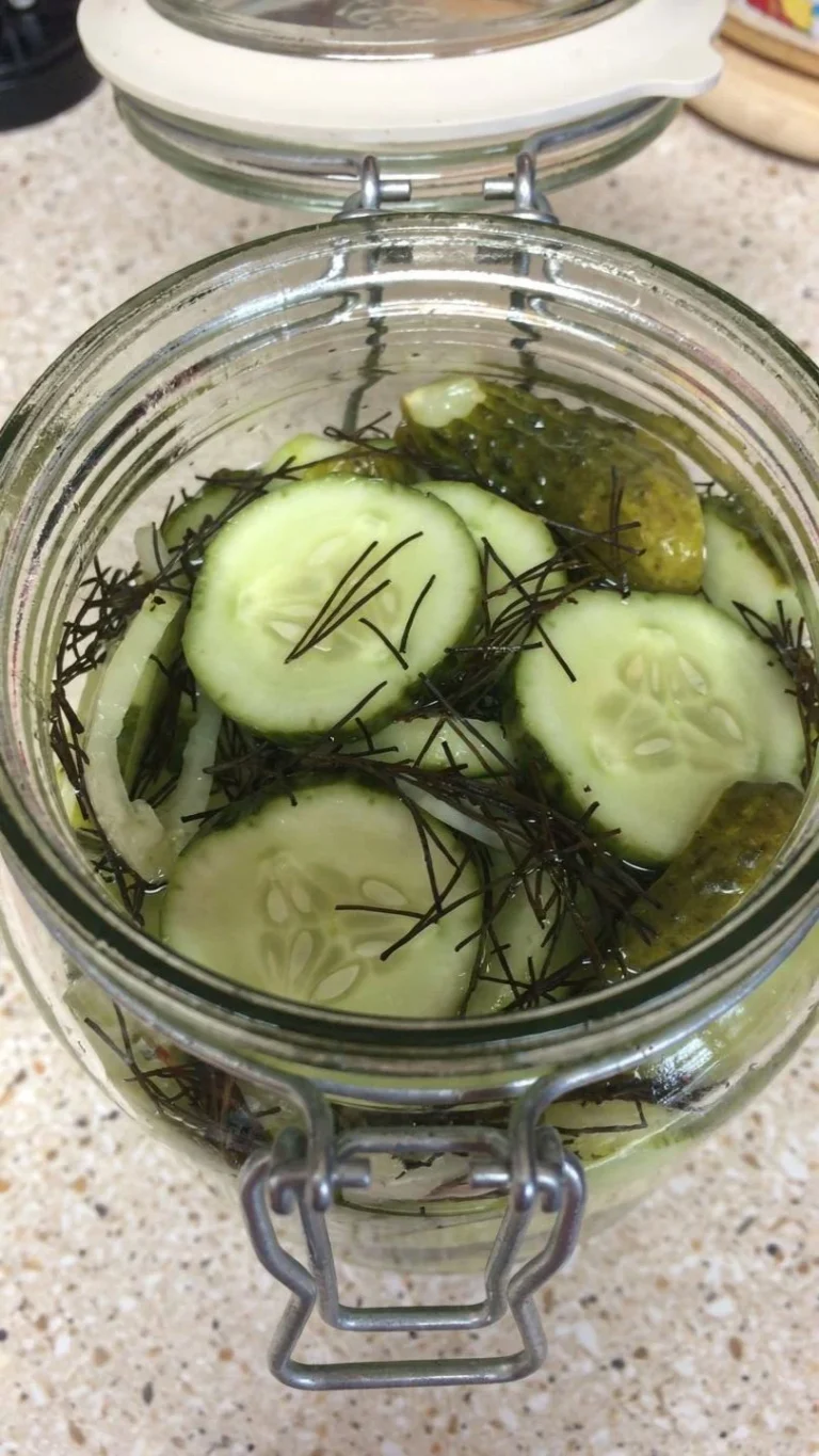 Creamy cucumber salad served in a bowl with fresh herbs and spices