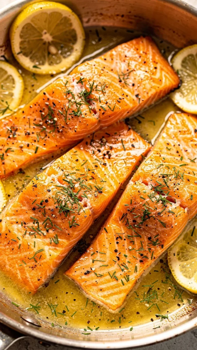 Lemon Dill Salmon plated with fresh herbs and lemon wedges